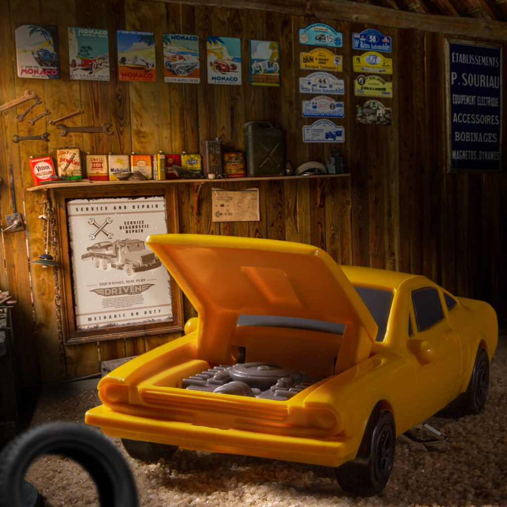 Yellow sports car with the hood open to see the engine inside.