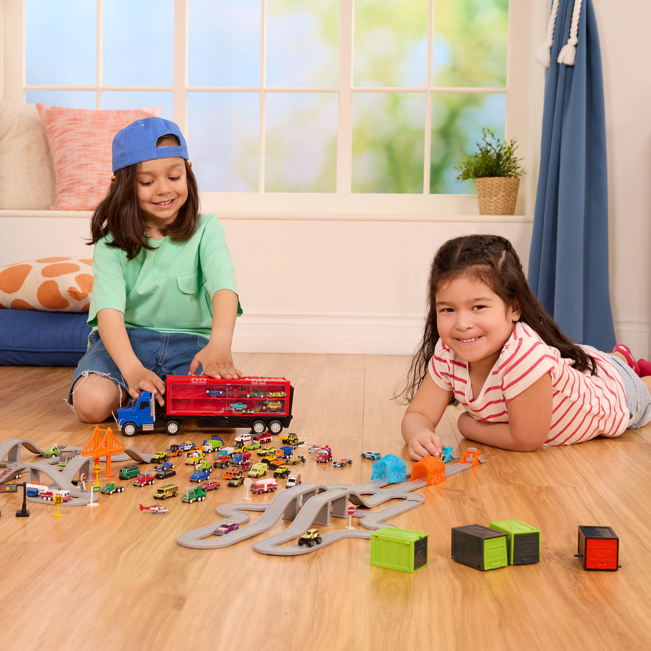 Kids with toy car tracks.