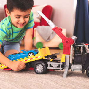tow truck toy with boy and blue car
